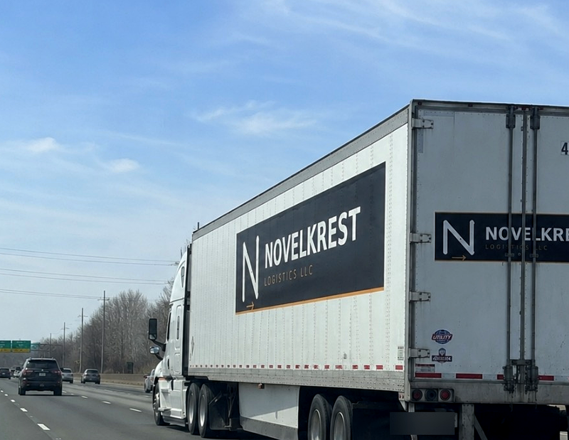 Novelkrest Logistics branded trailer on the highway